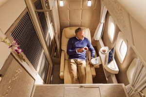 Emirates first class suite with relaxing passenger