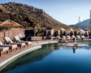 lounge chairs surround the pool at the Ritz-Carlton, Dove Mountain which is a Marriott Bonvoy property where you can enjoy the perks from your elite status
