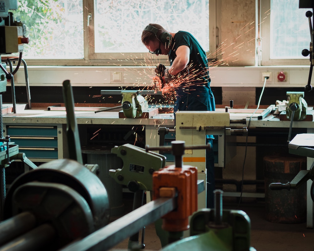 Person using a table saw in a workshop.