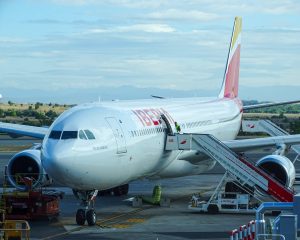 an Iberia plane with stairs attached ready for boarding