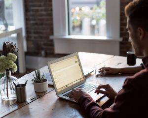 a man uses his laptop at a desk
