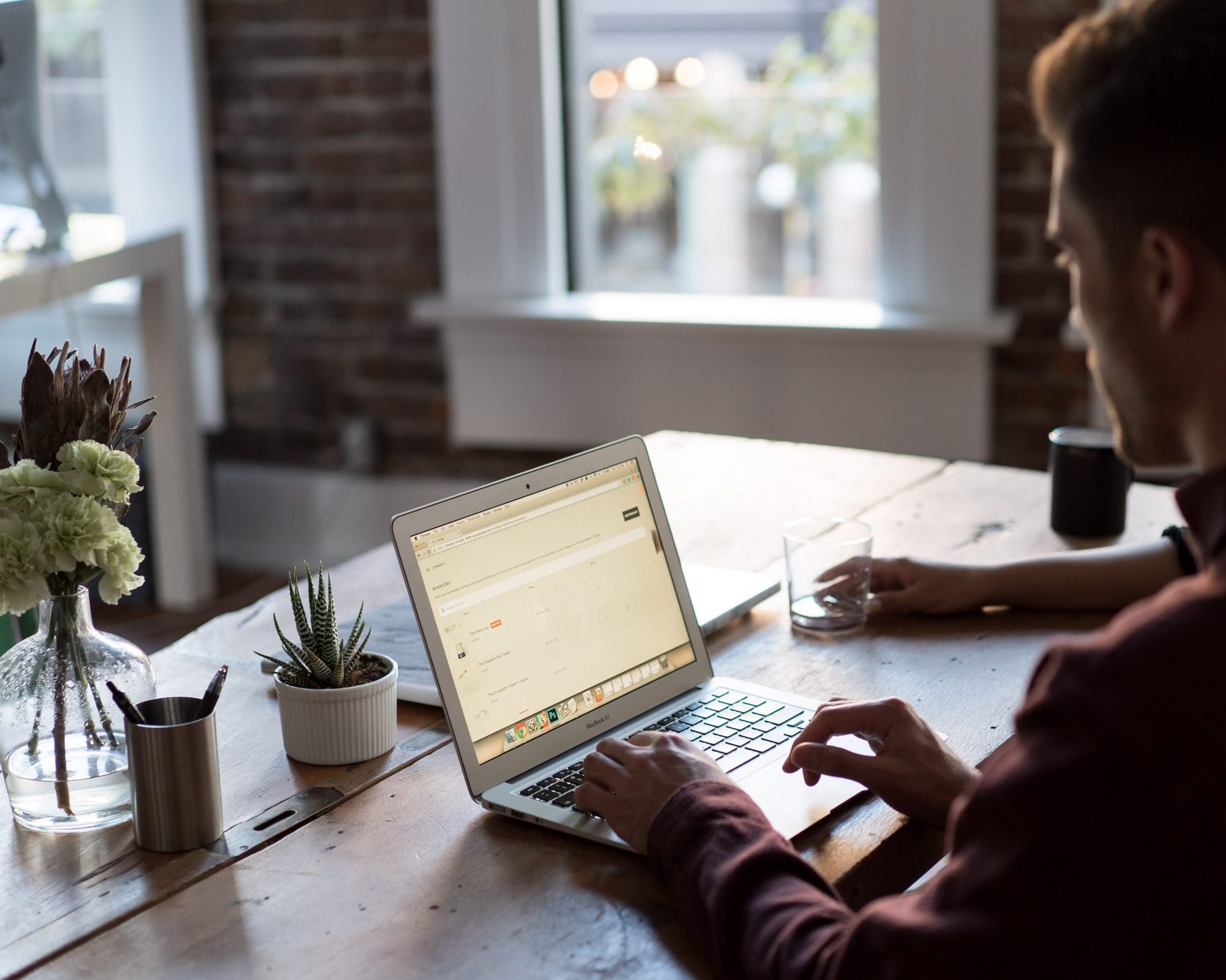 a man uses his laptop at a desk