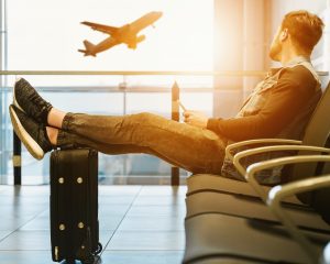 person waiting in an airport with luggage