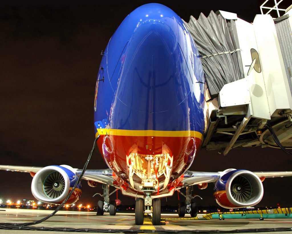 Nose of a Southwest Airlines aircraft at an airport gate at night