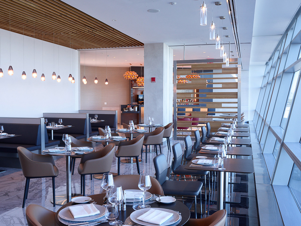 empty tables waiting for customers at American Airlines Flagship First Dining