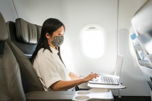 Image of woman working on a laptop in Alaska Airlines first class