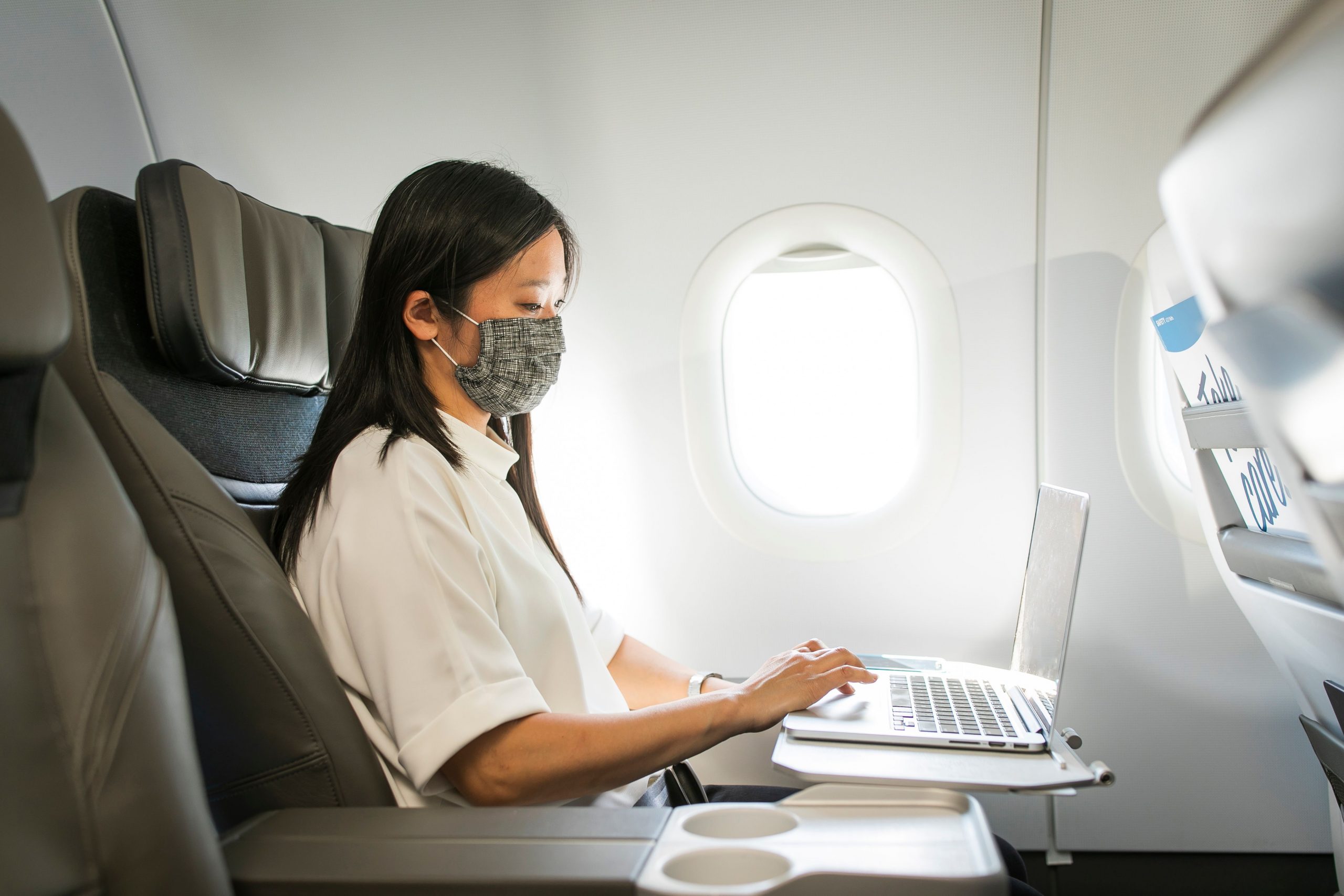 Image of woman working on a laptop in Alaska Airlines first class