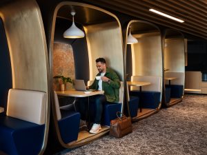 A traveler at a work station at the Chase Sapphire Lounge by The Club Hong Kong International Airport