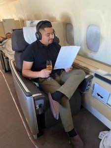 Lufthansa First Class passenger reads an information pamphlet