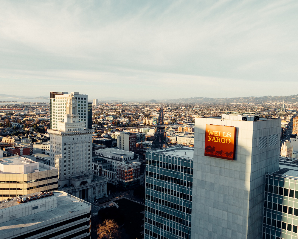 looking out over a city skyline with a large Wells Fargo logo on one building