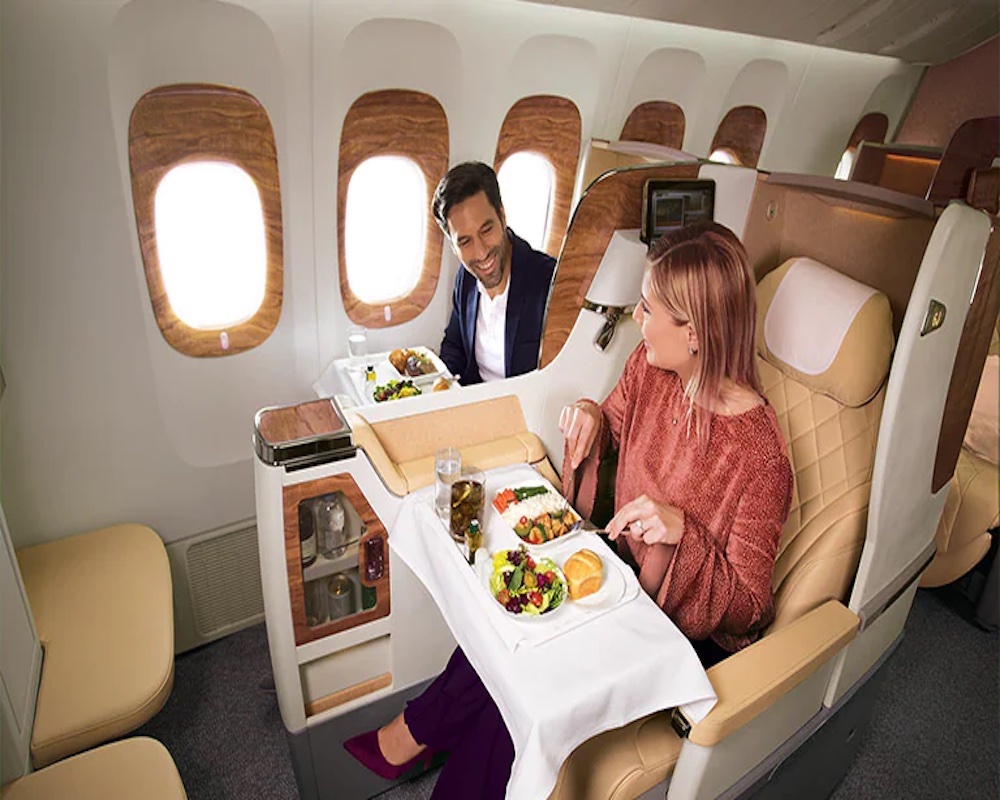 a couple having dinner in Emirates business class