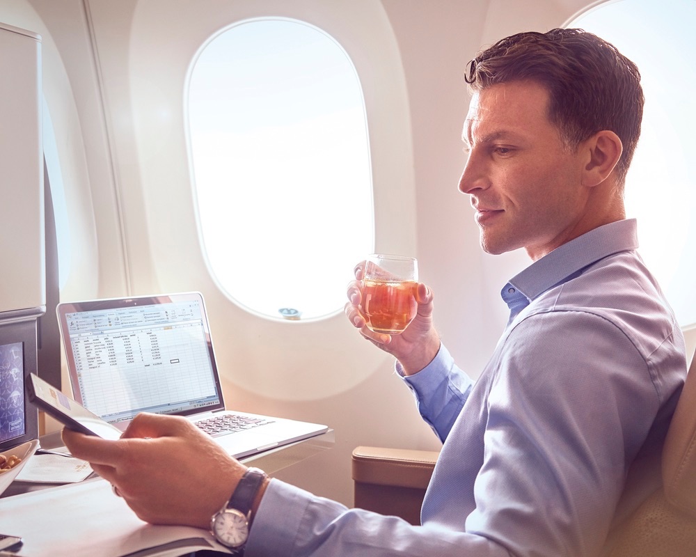 Man working in Etihad business class cabin.