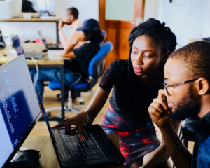 2 people look at a computer screen together