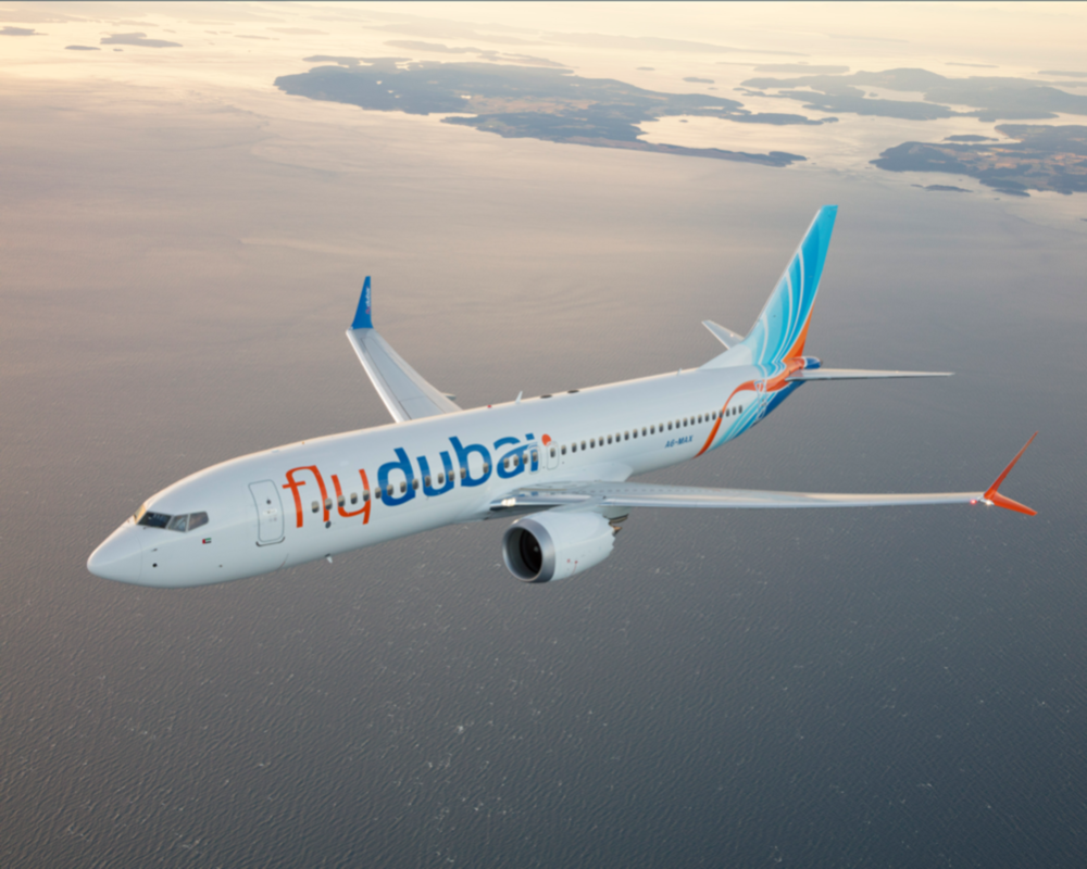 a plane with the flydubai logo is seen in flight