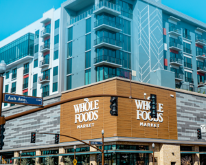 a Whole Foods store as seen from across the street; Amazon credit cards earn bonus cash back at Whole Foods stores like this one