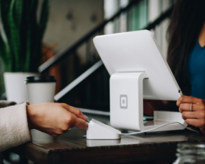 an unseen person inserts a credit card into a card reader