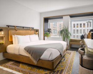 the interior of a hotel room overlooking a busy city