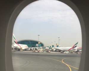 Emirates planes parked at the Dubai airport, as seen from a plane window