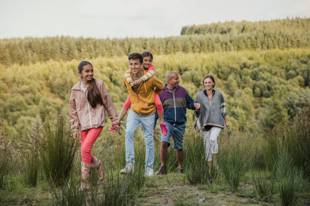 Family spending quality time together by hiking through the country side.