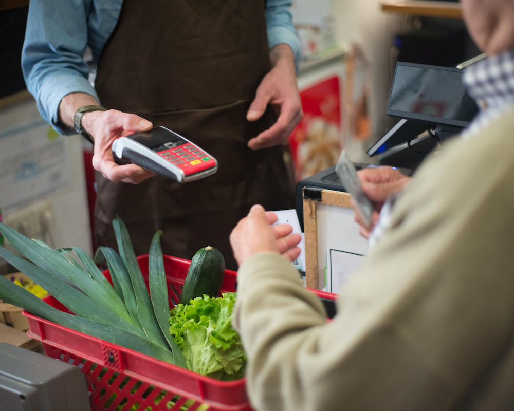 a customer pays by credit card at a supermarket cashier
