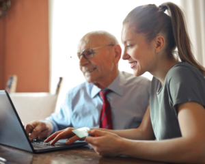 a student looks at a computer to learn about credit cards with a grandfather
