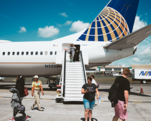 people deplaning from the rear door on a United Airlines plane
