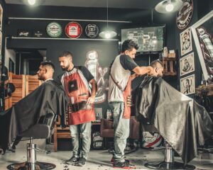 barbers cutting hair inside a small barber shop could benefit from US Bank Triple Cash Rewards