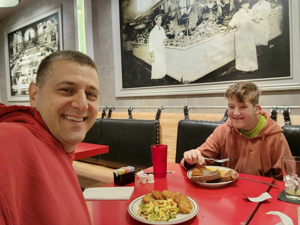 a father and son have a meal together at a restaurant