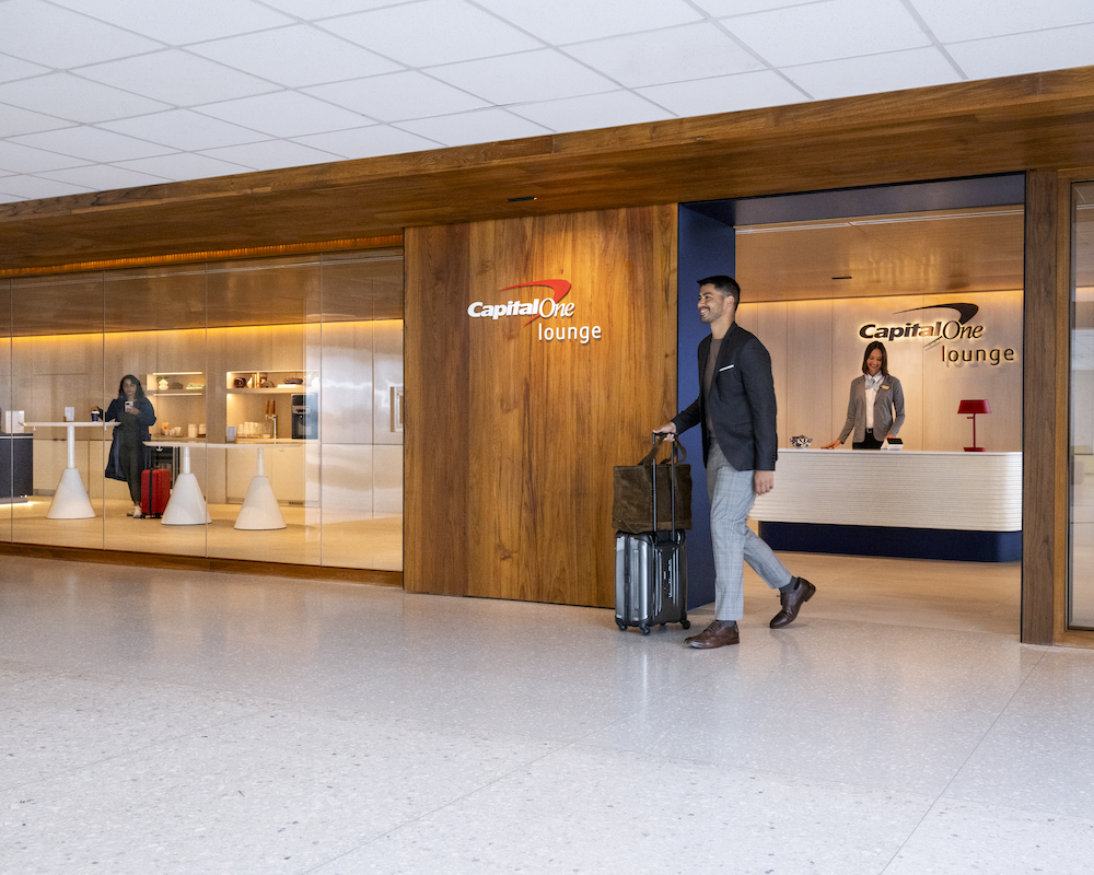 A passenger walks out of the Capital One Lounge at Washington Dulles IAD airport
