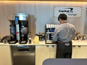 Photo of a Barista making a drink at the Capital One Lounge IAD
