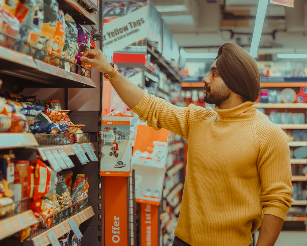 a person browses bags of chips in a large supermarket