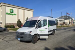 Photo of the outside of the Holiday Inn Elk Grove Village showing the hotel's airport shuttle