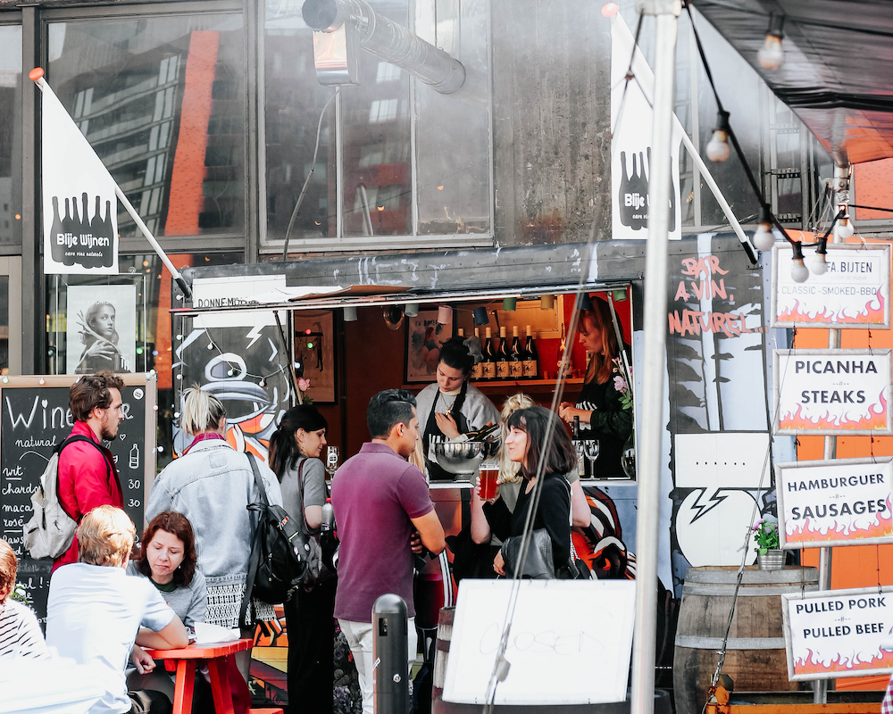 a line of customers at a food truck
