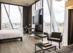 Room view of the AC Hotel by Marriott Guadalajara Mexico with cityscape in the background.