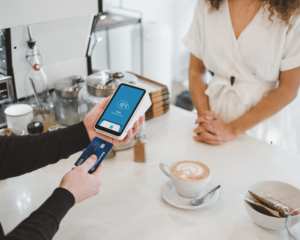 a customer pays by credit card at a coffee shop