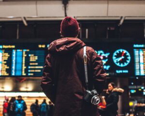 A passenger looking at departure boards in an airport
