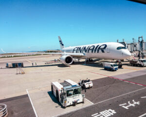 A Finnair plane parked at a gate in Tokyo