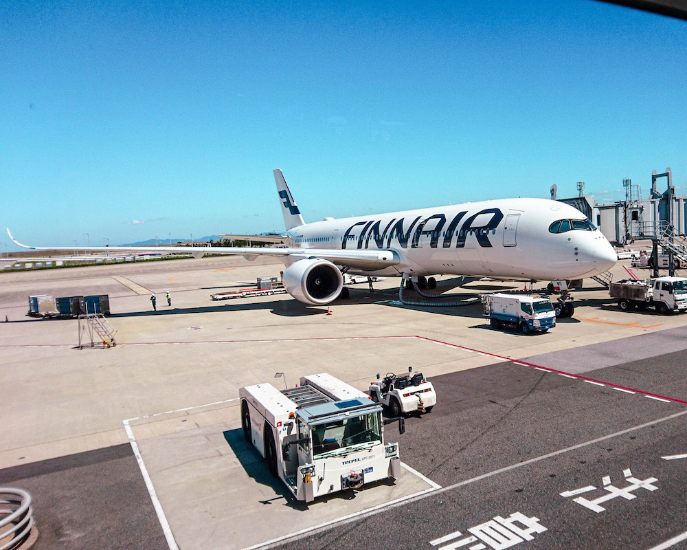 A Finnair plane parked at a gate in Tokyo