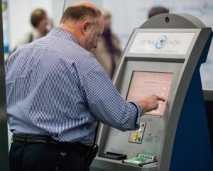 A traveler uses a Global Entry Kiosk at Newark Liberty International Airport EWR featured