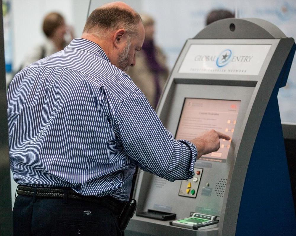 A traveler uses a Global Entry Kiosk at Newark Liberty International Airport EWR featured