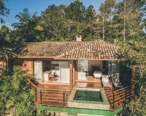 a wooden villa with private plunge pool set amongst trees at a luxury resort