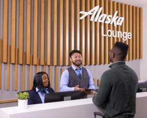 A customer at the reception desk at an Alaska Airlines lounge
