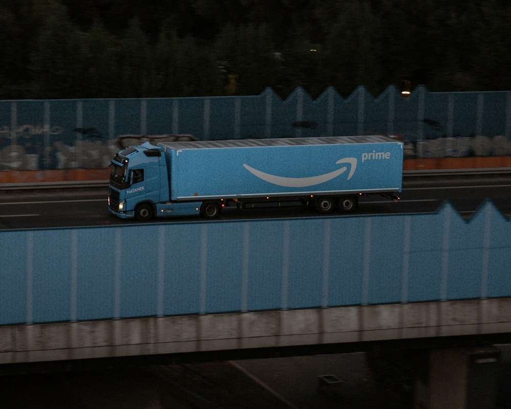 Amazon Prime 18-wheeler truck driving on an overpass.