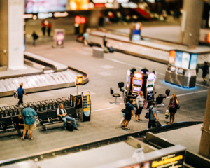 looking down at a busy baggage claim hall at an airport