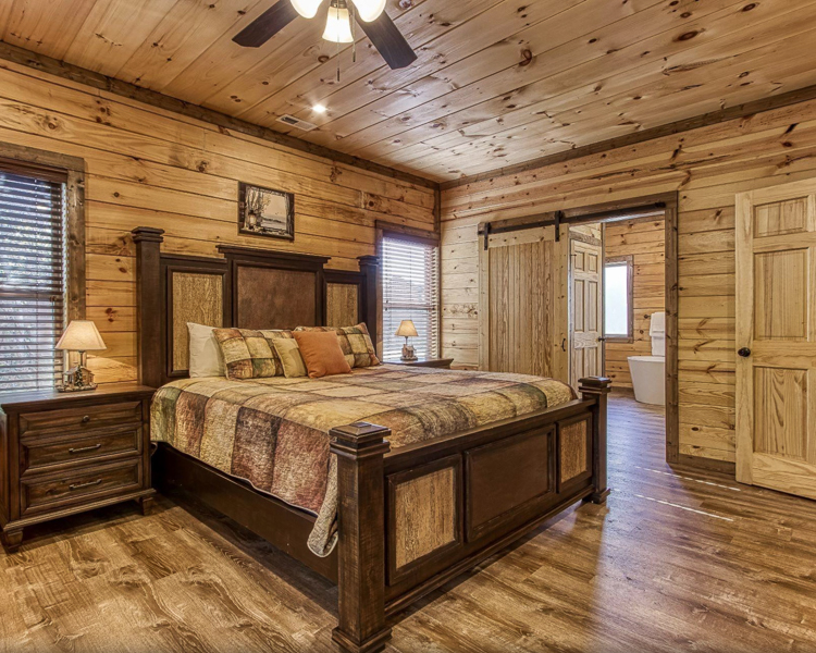 the bedroom in a wood-themed vacation home rental in Tennessee