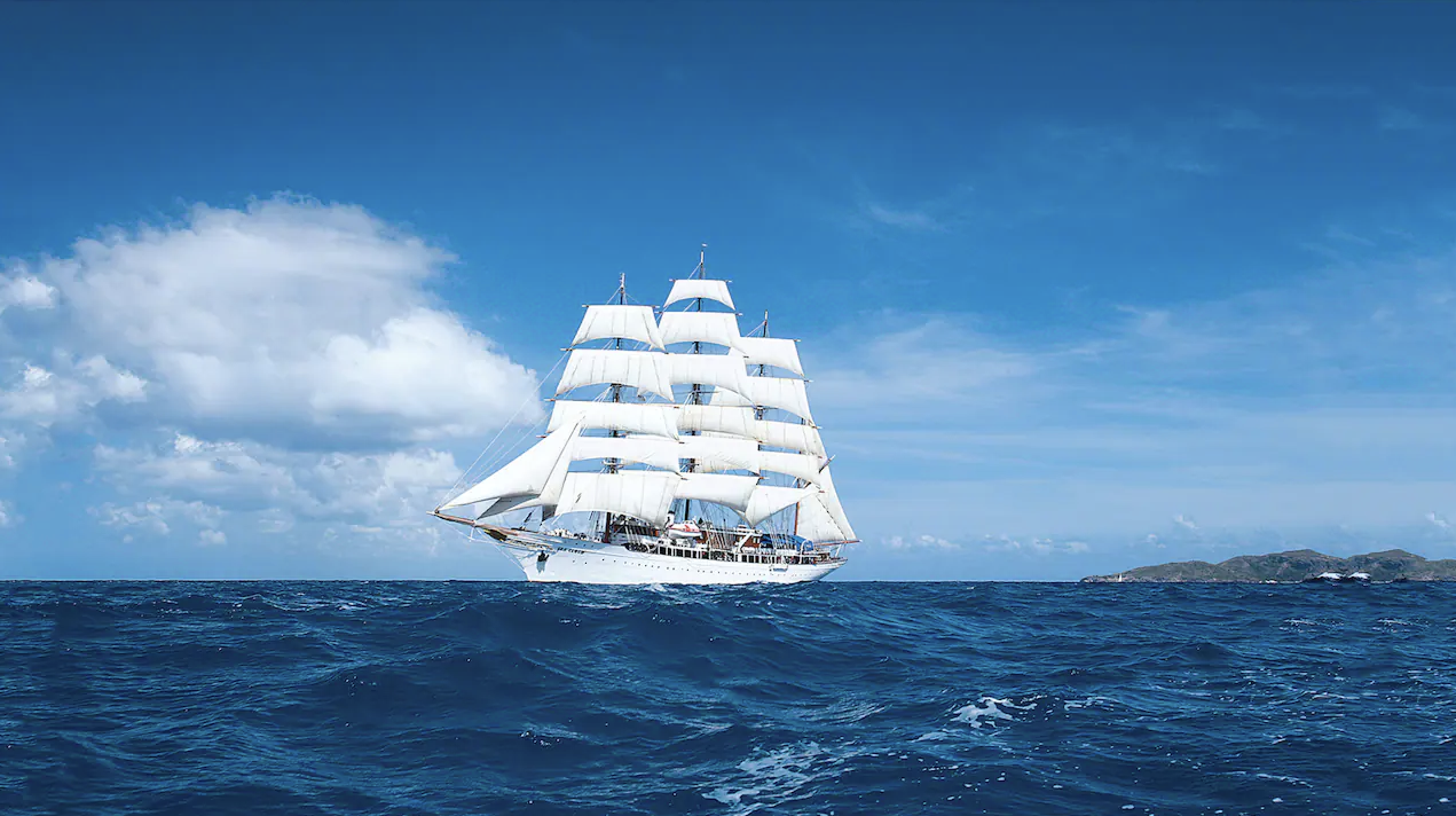 Lindblad Expeditions' Sea Cloud ship in blue ocean water.