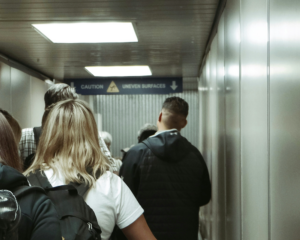 passengers in a jet bridge waiting to board a plane