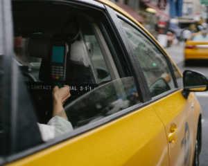 view of a person paying for a New York City taxi ride with a credit card