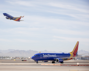 Southwest Airlines planes, one on tarmac another taking off