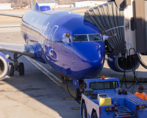 Southwest plane at gate with pilots waving from windows